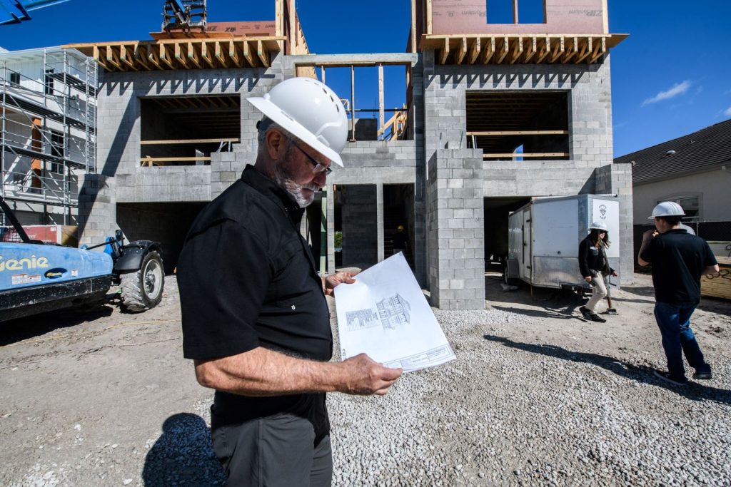 Alair Bonita Springs and Dave Jenkins of Wright Jenkins Home Design reviewing the home's floor plan