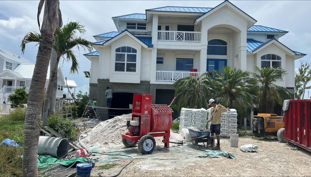 Workers restoring a home in Florida after a hurricane, focusing on repairs and rebuilding to ensure safety and quality.