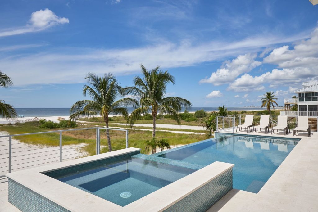 Infinity edge swimming pool with a spa, overlooking Fort Myers Beach.